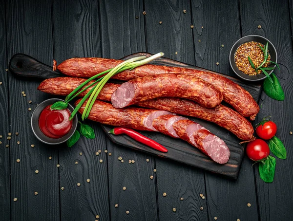 Ev yapımı füme sosis yüzüğü. Siyah arka planda sosis. Menü için fotoğraf