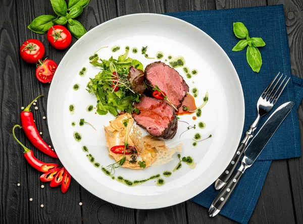 Salata ve humus ile dana madalyonu. Restoranda yemek servisi. Sağlıklı gıda konsepti. Menü için fotoğraf