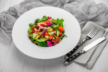 Salad with seafood and fresh vegetables. Healthy salad plate. Salad with fresh vegetables, mussels, shrimps and squids