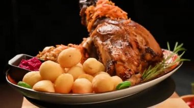 Fırında domuz budu, patates ve lahana.