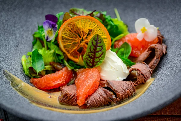 Fresh salad with roast beef, grapefruit and cream cheese. healthy food.
