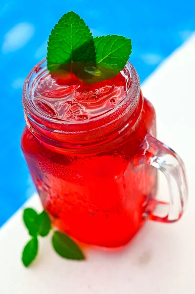 Cold strawberry lemonade in mason jar isolated, Lemonade pool background