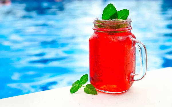 Cold strawberry lemonade in mason jar isolated, Lemonade pool background