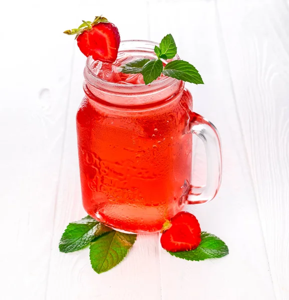 Cold strawberry lemonade in mason jar isolated on white background