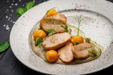 Fried bull testicles with potatoes and mushroom sauce. Photo for the restaurant menu
