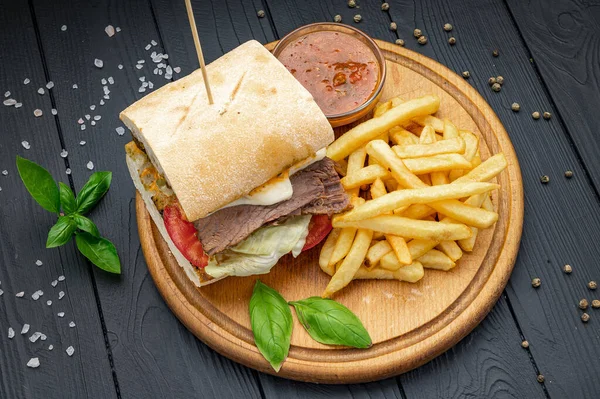 Smoked beef panini sandwich, served with salad and french fries. Photo for the restaurant menu