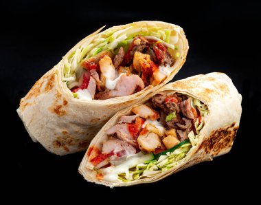 Beef shawarma on a dark background. Shawarma with beef in pita bread. Photo for the menu
