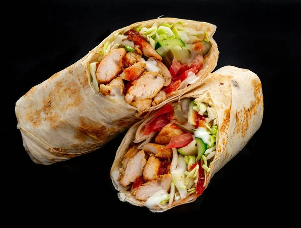 Beef shawarma on a dark background. Shawarma with beef in pita bread. Photo for the menu