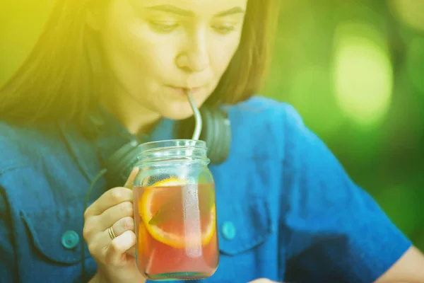 girl in cafe is drinking lemonade using metal reusable straw