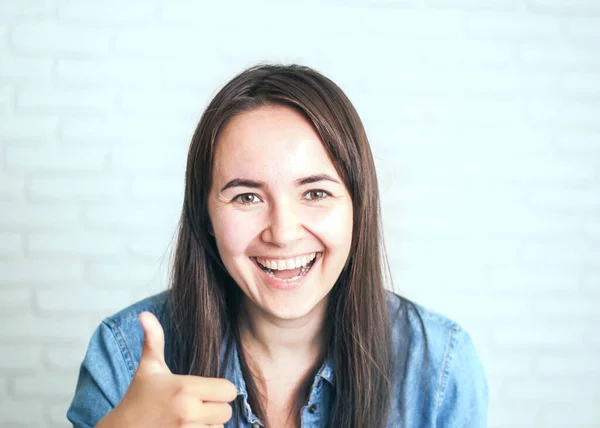 positive woman smiling on a light background. High quality photo