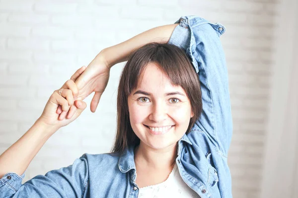 positive woman smiling on a light background. High quality photo