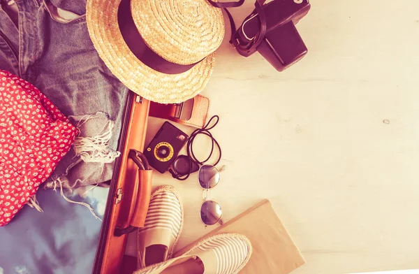 retro bag for summer vocation with photo camera, book and wicker hat. High quality photo