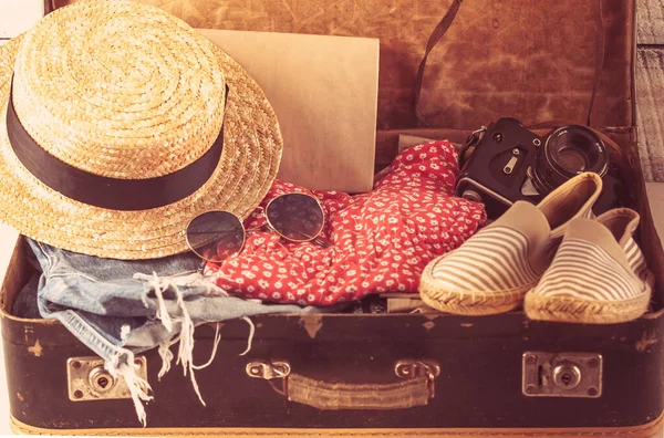 retro bag for summer vocation with photo camera, book and wicker hat. High quality photo