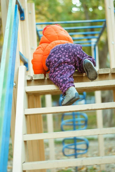the child climbs the steps on the playground. High quality photo