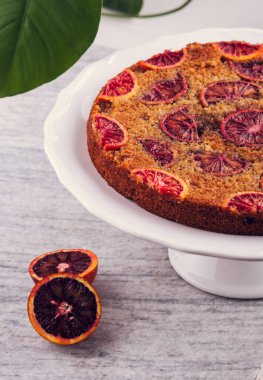 Üstünde kırmızı portakal dilimleri olan lezzetli bir pasta. Yüksek kalite fotoğraf.