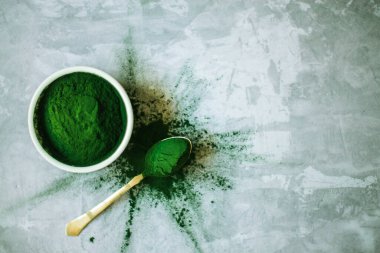 Beton zemin üzerinde beyaz plakalı spirulina tozu. Yüksek kalite fotoğraf