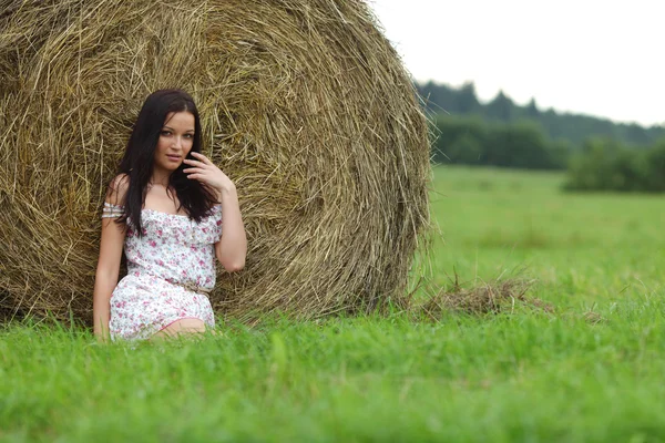 Girl next to haystack — Stock Photo, Image