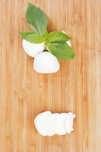 Sliced mozzarella on wooden board — Stock Photo, Image