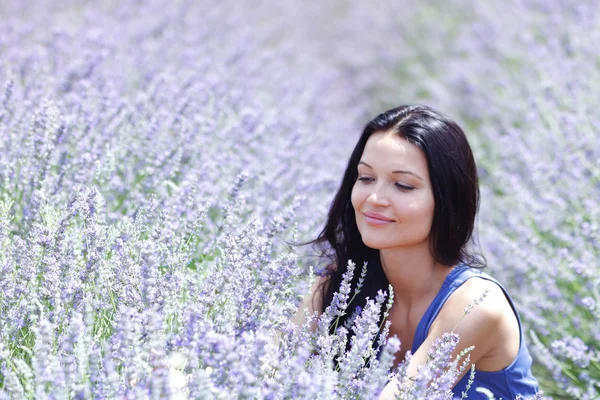 Woman sitting on a lavender field — Stock Photo, Image