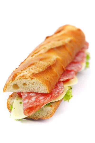 Long sandwich with salami tomatoes isolated on white — Stock Photo, Image