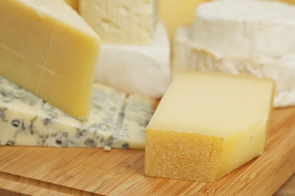 Cheese on a wooden table — Stock Photo, Image