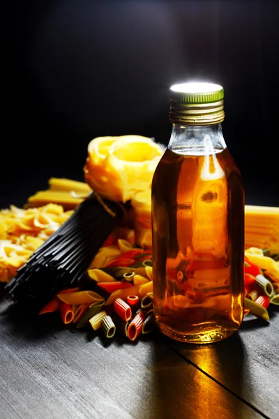 Raw pasta and oil — Stock Photo, Image