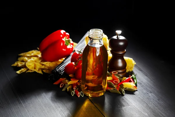 Pasta ingredients on black table — Stock Photo, Image