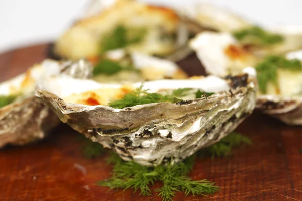 Oysters under cheese and dill — Stock Photo, Image