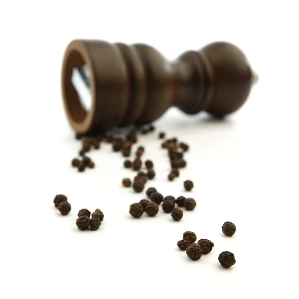 Wooden peppermill with peppercorns — Stock Photo, Image