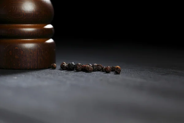 Wooden peppermill with peppercorns — Stock Photo, Image