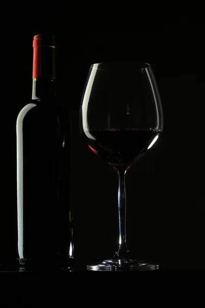Rött vin glas silhuett svart bakgrund — Stockfoto
