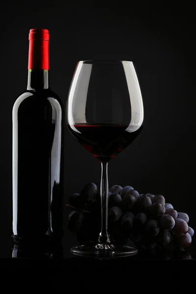 Bottle with red wine and glass and grapes — Stock Photo, Image