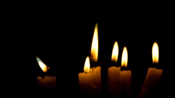 Closeup of burning candle isolated on black background — Stock Video