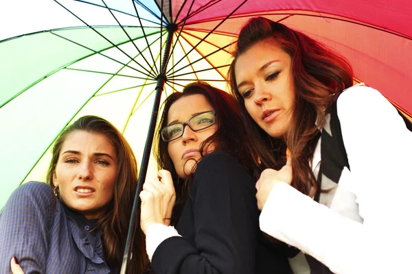 Girlfriends under umbrella — Stock Photo, Image