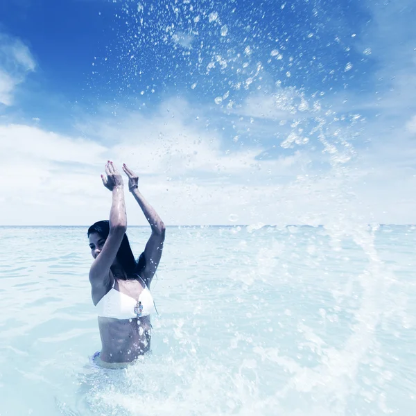 Mujer salpicando en el mar — Foto de Stock