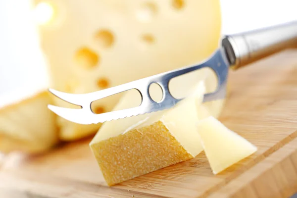 Cheese with a cheese knife — Stock Photo, Image