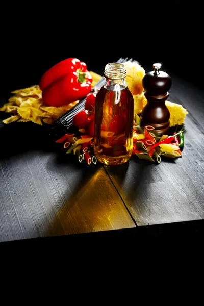 Pasta ingredients on black table — Stock Photo, Image