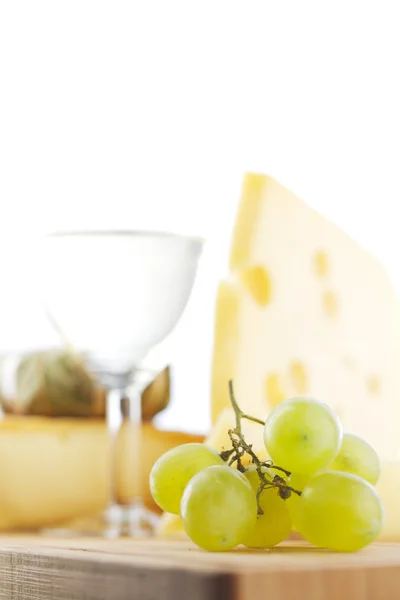 Queijo e vinho em uma mesa de madeira — Fotografia de Stock
