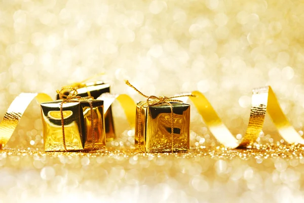 Golden gifts and ribbon — Stock Photo, Image