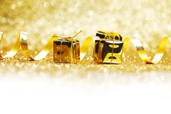 Golden gifts and ribbon — Stock Photo, Image