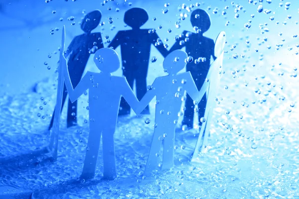 Paper team under rain — Stock Photo, Image