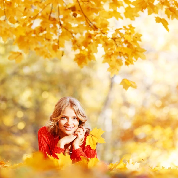 Vrouw opleggen Herfstbladeren — Stockfoto