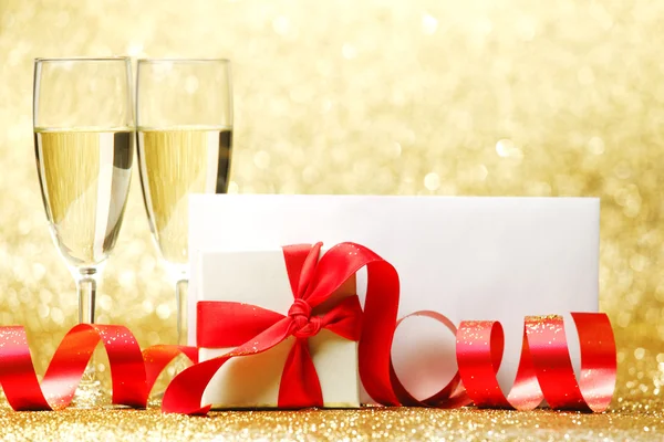Champagne glasses and gift Royalty Free Stock Images