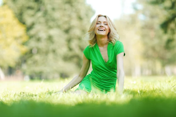 Femme assise sur l'herbe — Photo