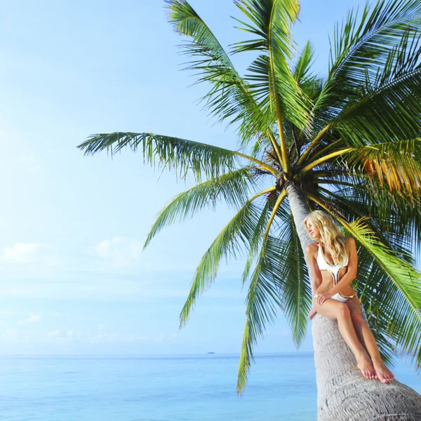 Woman sitting on palm — Stock Photo, Image