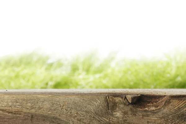 Wooden plank and grass — Stock Photo, Image