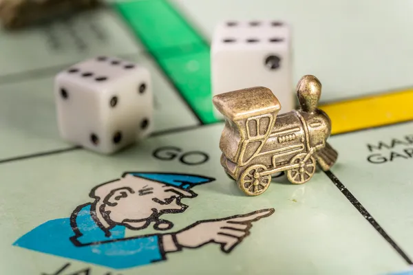 Train monopoly piece on go to jail space — Stock Photo, Image