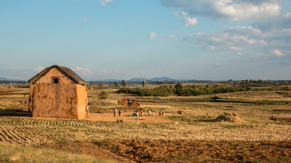 Malagasy village kids play games next to their house in the highland regions of central Madagascar on May 22, 2014.