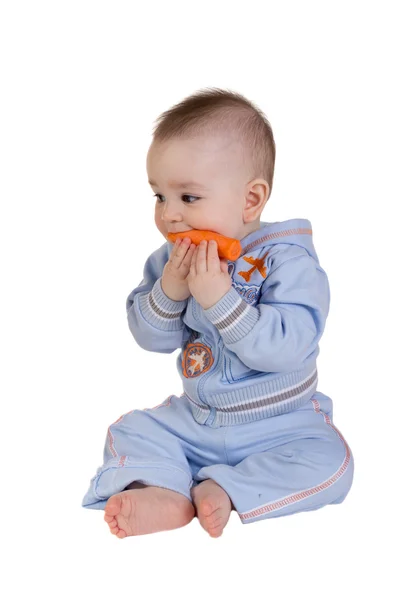 Smiling baby eats carrot — Stock Photo, Image