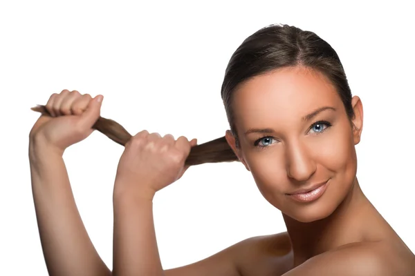 Beautiful girl with blue eyes holds hers ponytail — Stock Photo, Image